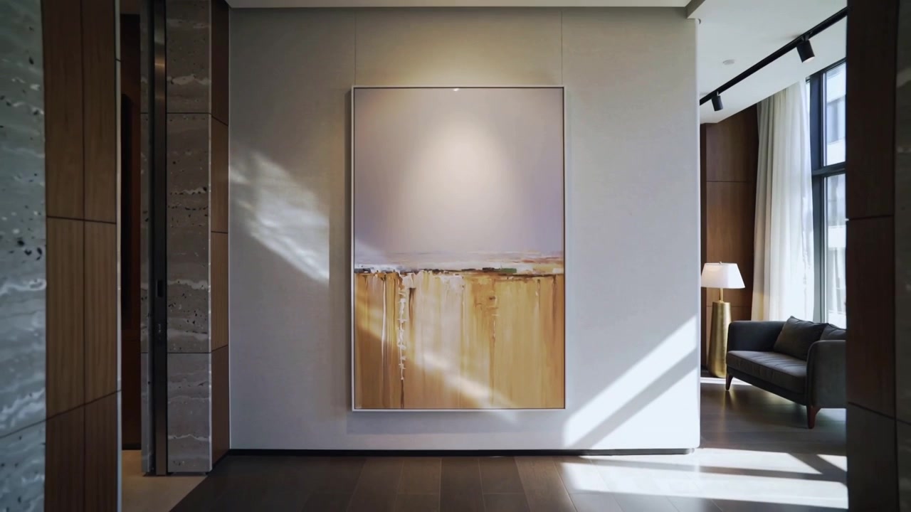 Pulling back camera showing abstract painting on foyer, exposing marble and window to show design