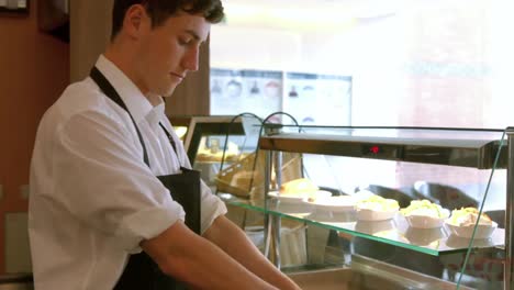 deli worker preparing a panini