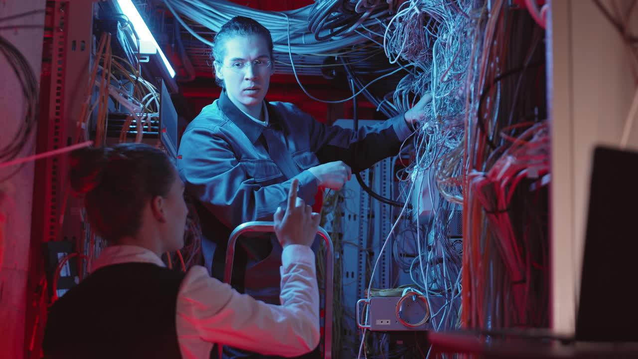 Technicians Working in Server Room