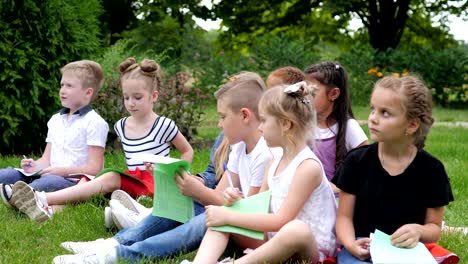 group of cheerful children learning outdoors at school after quarantine lockdown