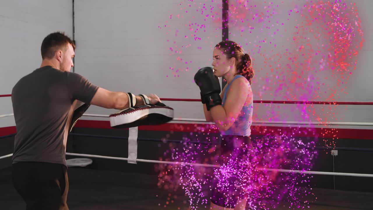 Female boxer following coach shifting mitts in boxing ring, drilling combos with pink purple glow