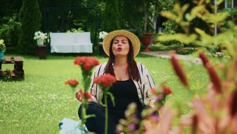 woman in straw hat enjoying peaceful moment among vibrant flowers in a serene garden setting