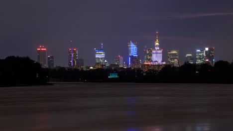 thunder storm over warsaw, poland with reflections of the skyscrapers and lighting in the vistula river.