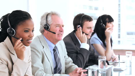 serious call centre agents talking with headsets