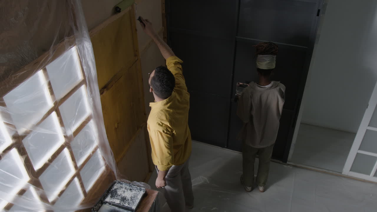 People Painting a Wall