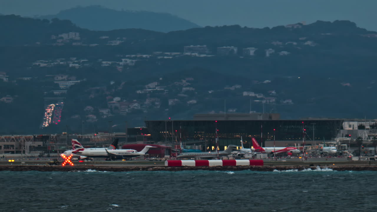 Nice, France - January 10, 2025: Airplane moving at the Nice Cote d'Azur Airport in the evening with the mountains on the background