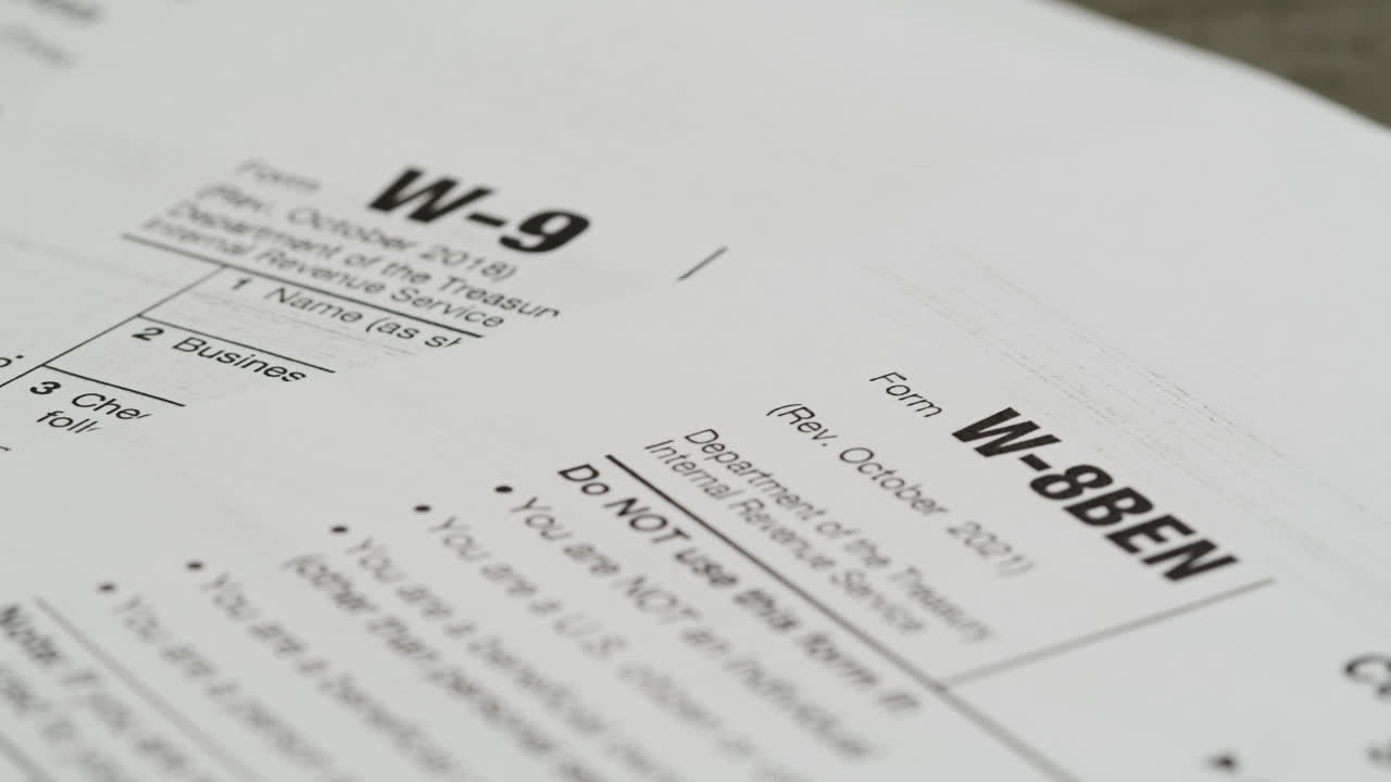 Close-up Pan of IRS Tax Forms W-9 and W-8BEN