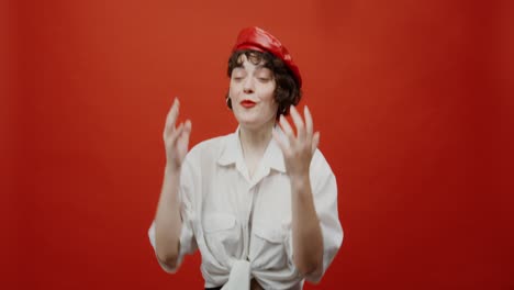 woman in a red beret, expressing joy