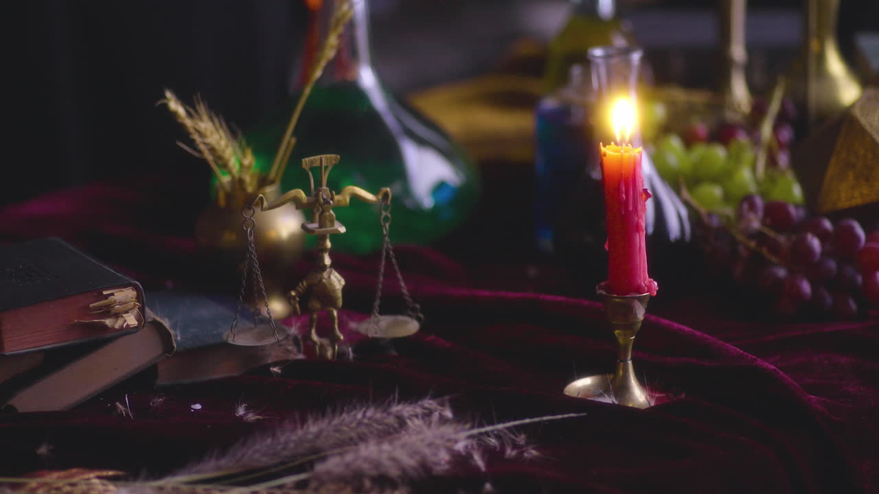 Symbolic Balance: Lit Red Candle and Scale of Justice with Sword and Feather