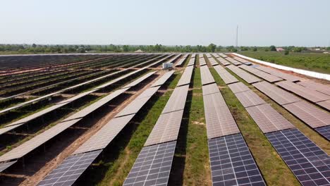Low closeup aerial view of dirty dusty and clean solar modules in contrast and surrounded by natural forest