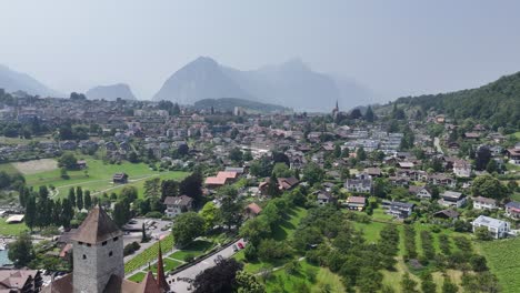 spiez town on lake thun switzerland drone, aerial mountains in background