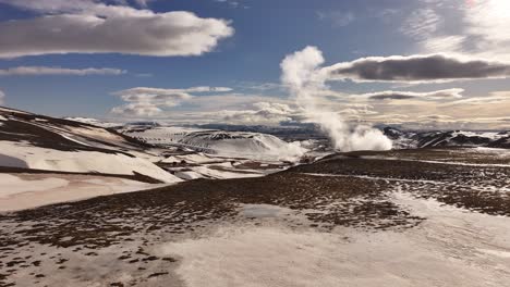 steam plume over snow covered hills at námafjall geothermal area iceland