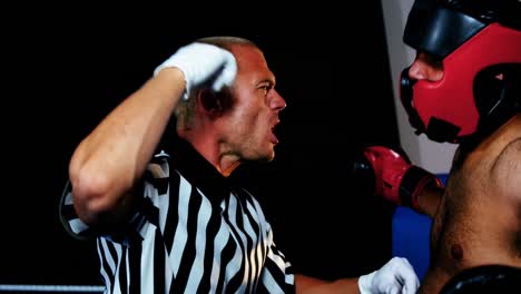 referee shouting at boxer