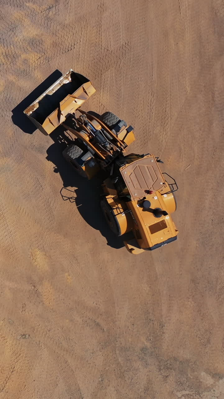 Construction of new road. Construction machinery for the construction of road Vertical video