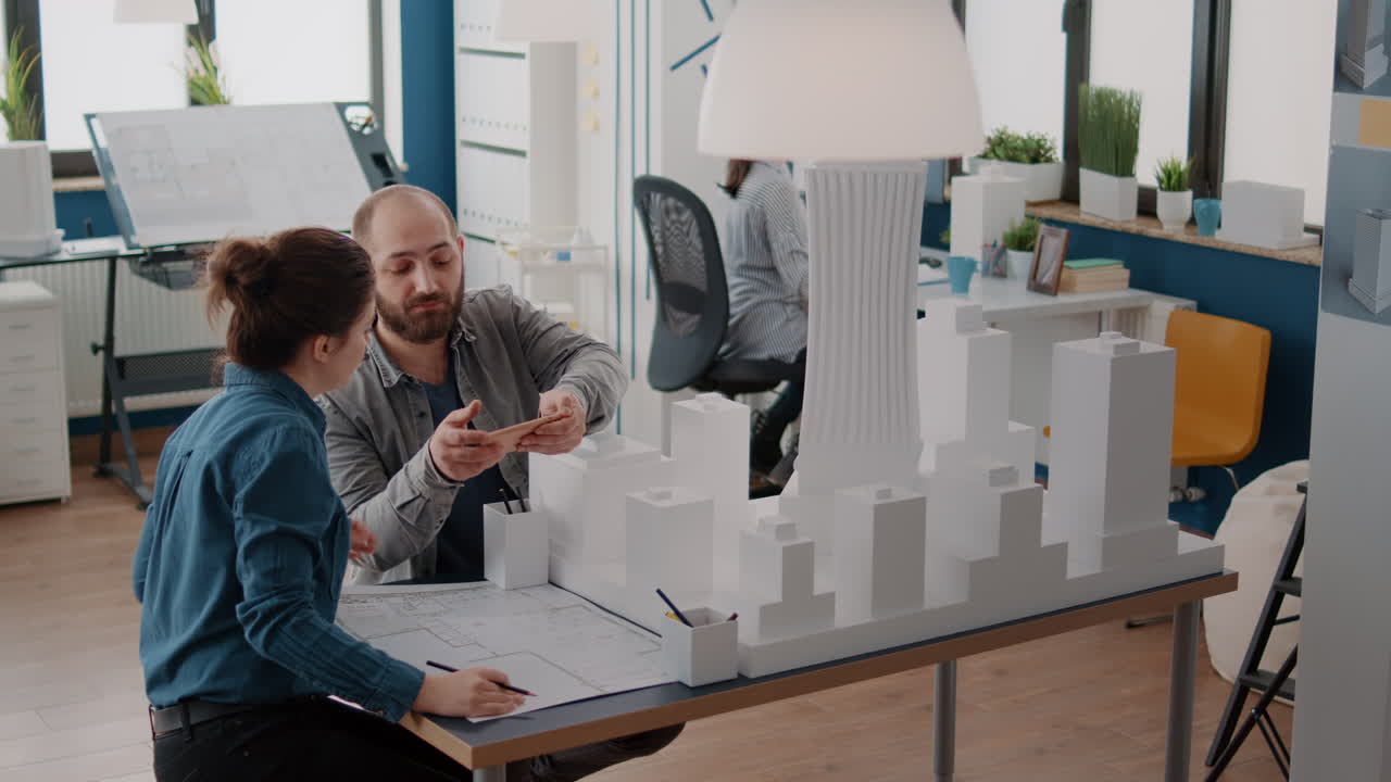 Architects collaborating on a building design in an office