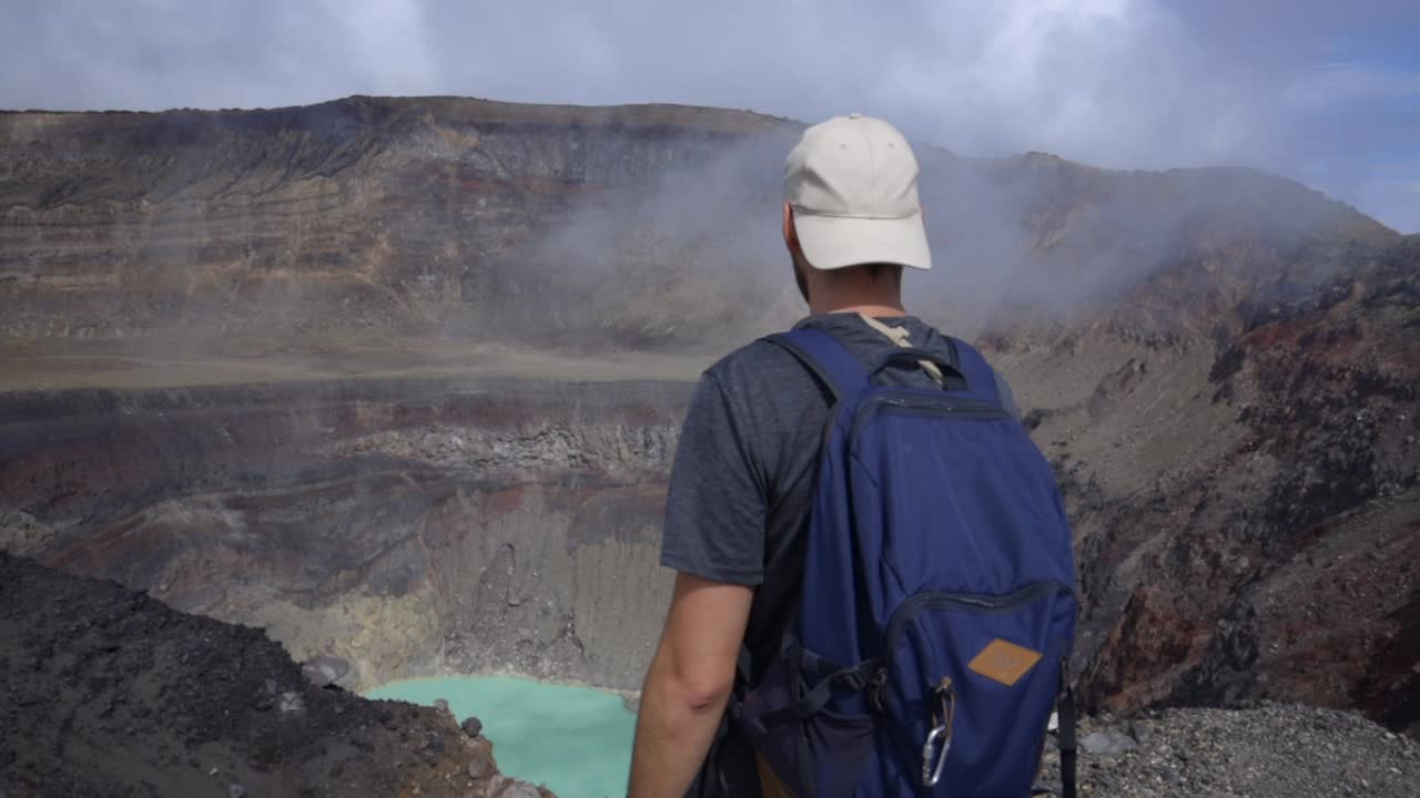 Tourist at Santa Ana Volcano El Salvador looking at crater lake landscape
