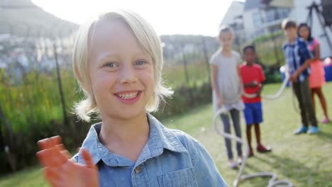 Portrait-of-happy-boy-gesturing-in-backyard-4k