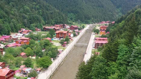 aerial drone view of a mountain village near a river and forest on a sunny summer day in uzungol trabzon turkey