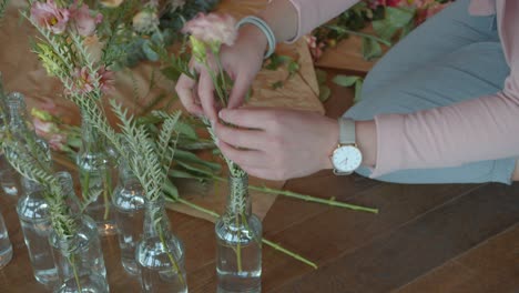 woman preparing beautiful floral decor for upcoming wedding, handheld view