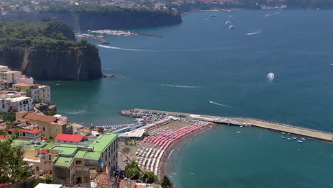 view looking down on beach covered with parasols in amalfi coast