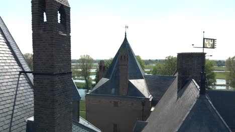 Drone-Volando-Entre-Los-Techos-Del-Castillo-Loevestein-Que-Termina-En-Una-Amplia-Toma-Del-Monumento-En-Un-Brillante-Día-Soleado-En-Holanda