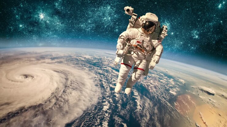 Astronaut in outer space against the backdrop of the planet earth. Typhoon over planet Earth. Elements of this image furnished by NASA.