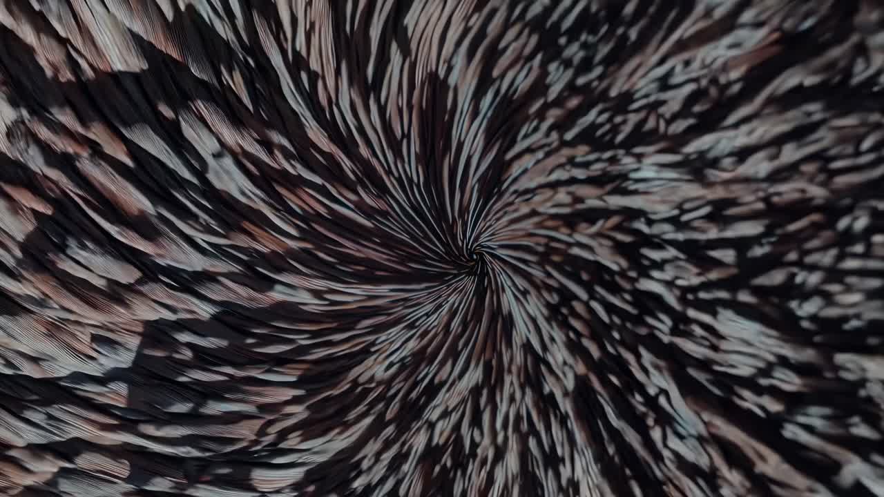 Abstract video with a swirling vortex pattern, top-down camera angle, featuring dynamic