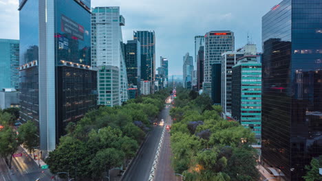 Aerial-hyperlapse-street-view-of-busy-urban-traffic-on-multi-lane-road-surrounded-by-tall-modern-skyscrapers-in-Mexico-City