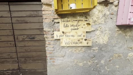 motto written on wood for grape harvest festival of medieval penna in teverina town with decorated houses and streets, italy