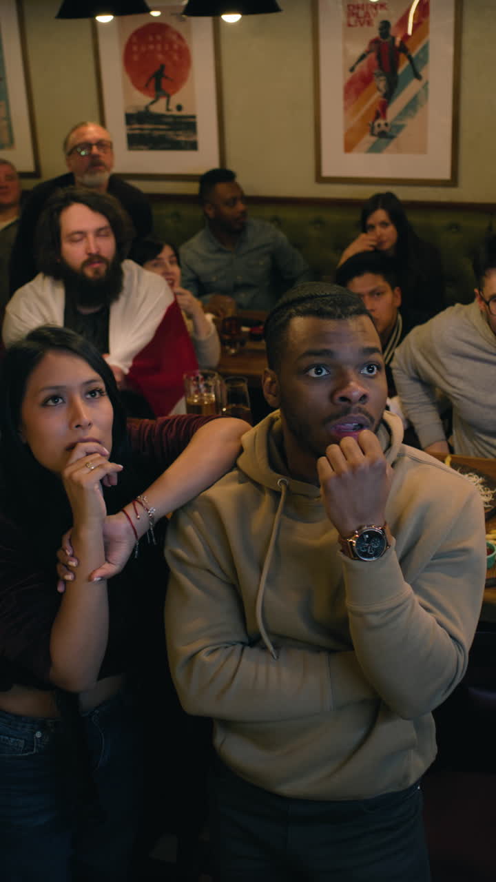 Soccer Fans Celebrating a Match in a Pub