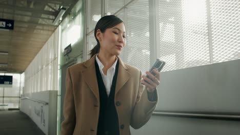 woman using phone in a station