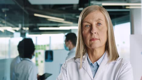 Close-up-view-of-caucasian-senior-female-doctor-looking-at-camera-in-hospital-office