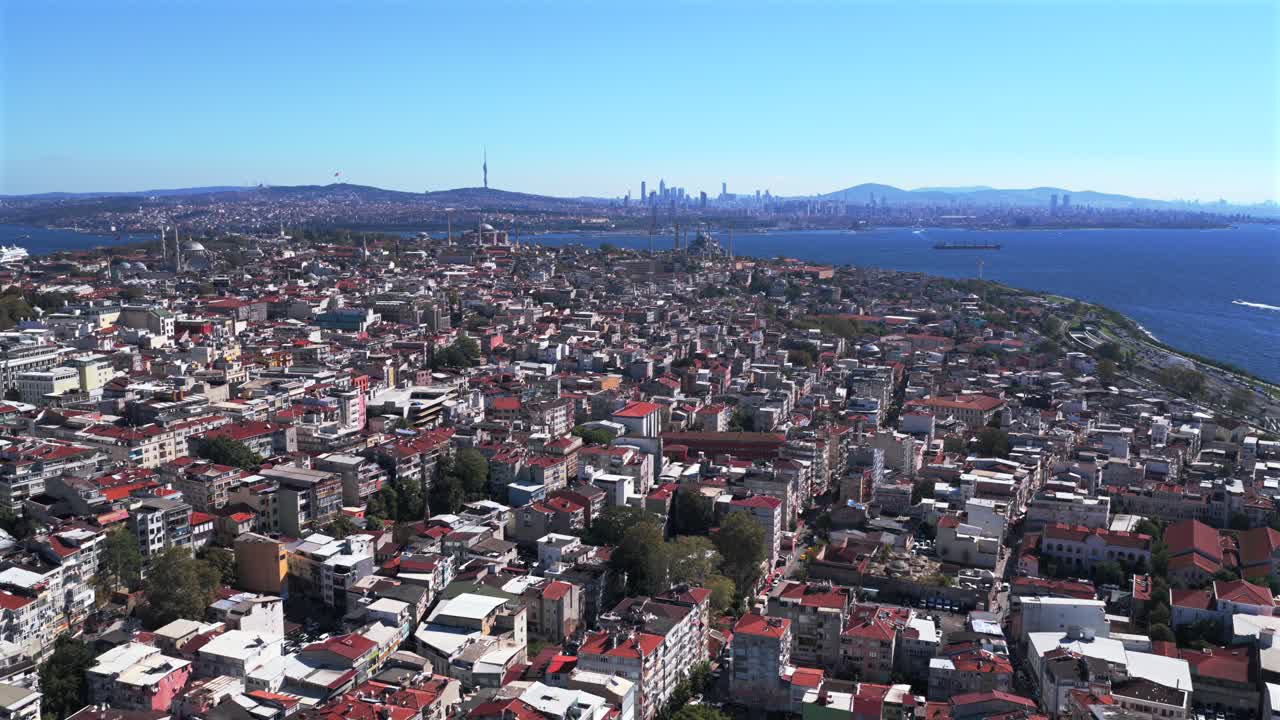 Morning Istanbul Turkey Türkiye aerial drone the Golden Horn Blue Mosque temple Hagia Sophia Grand Mosque cityscape buildings Bosphorus Strait river ferries boats harbor view blue sky circle left