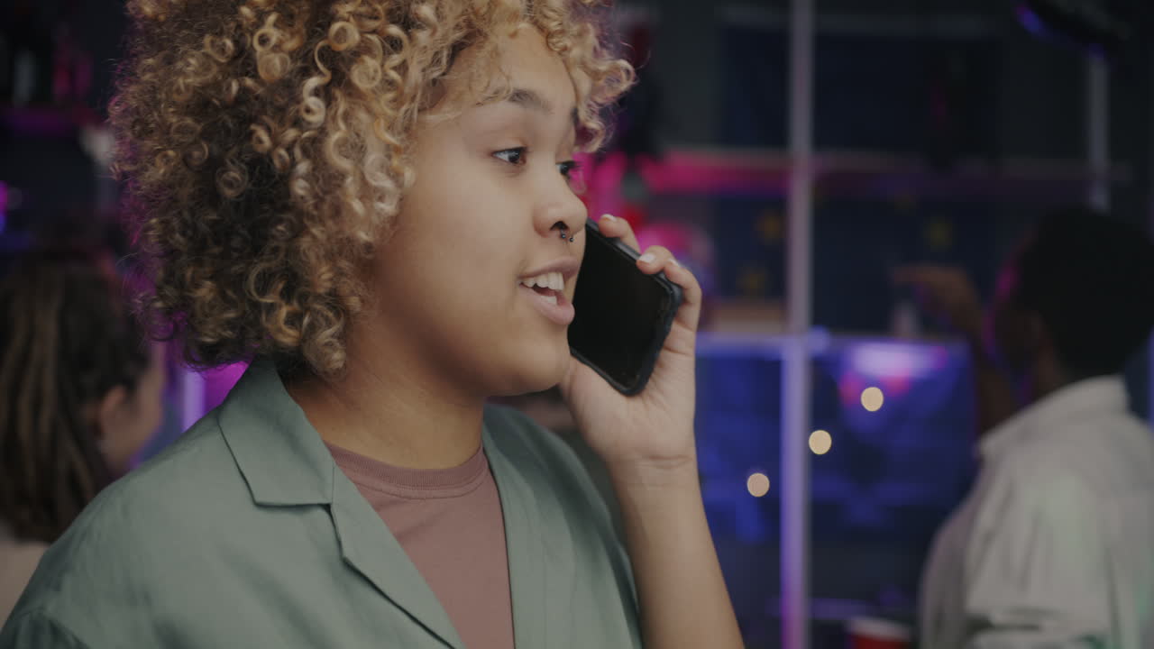 Woman talking on the phone at a party