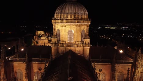 Cathedral-lantern-illuminated-at-night,-aerial-view-closing-the-distance