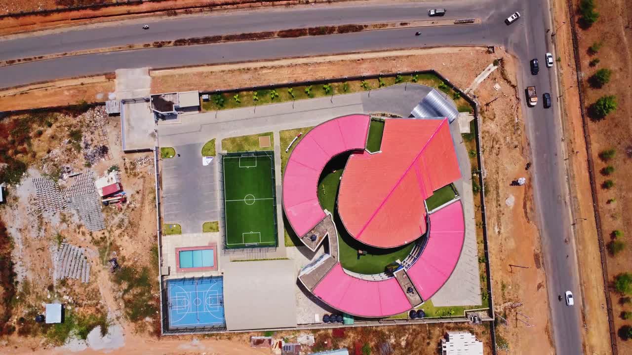 Top down view of a luxurious private school with a football field, tennis court and swimming pool in the couryard in Abuja, Nigeria