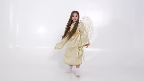 little girl with angel wings dancing on a white background little girl with angel wings dancing on a white background amazing image of a little angel