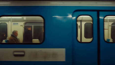 speeding blue subway train with passengers