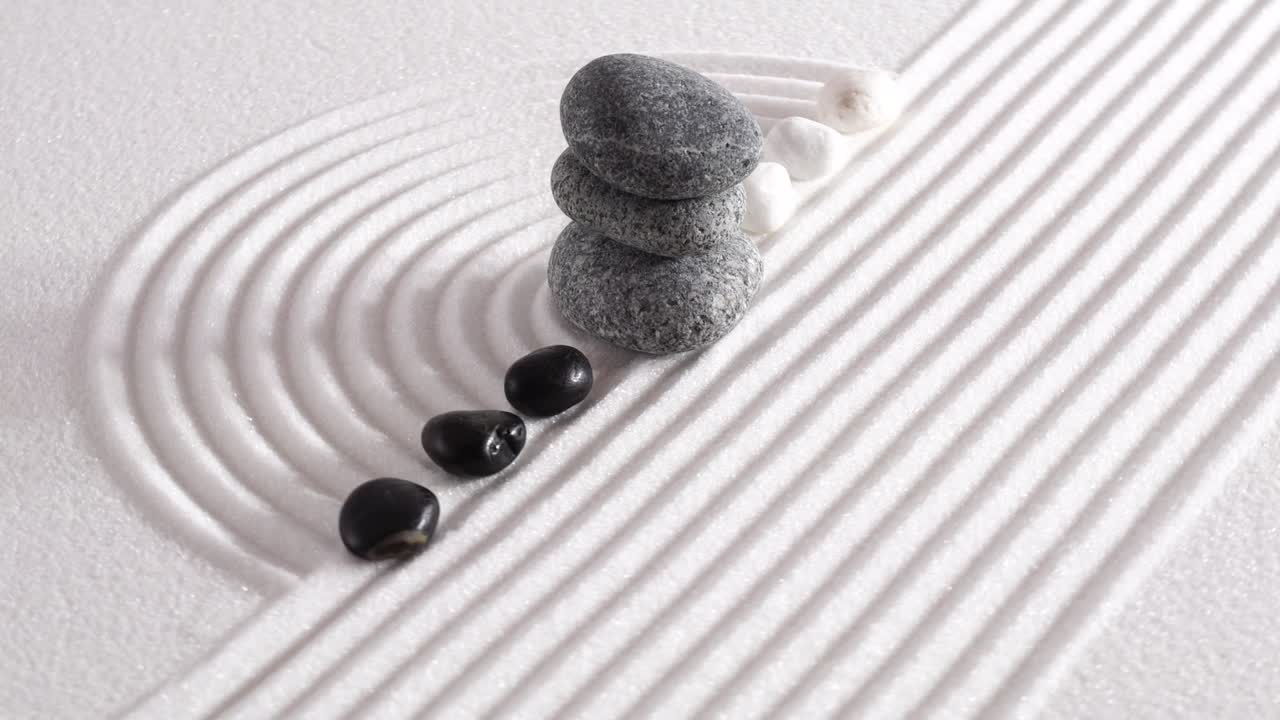 Japanese garden with yin yang stones laying in textured sand