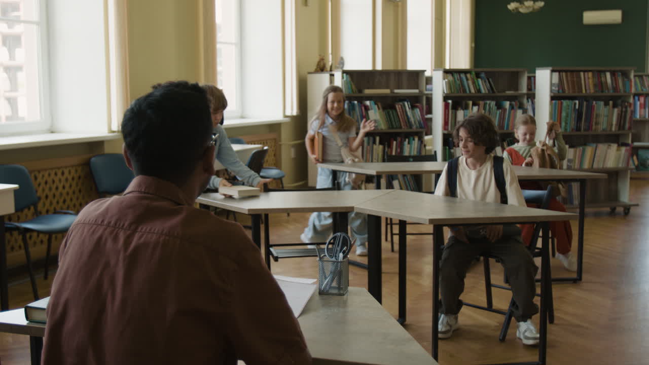Students settling into a school library classroom