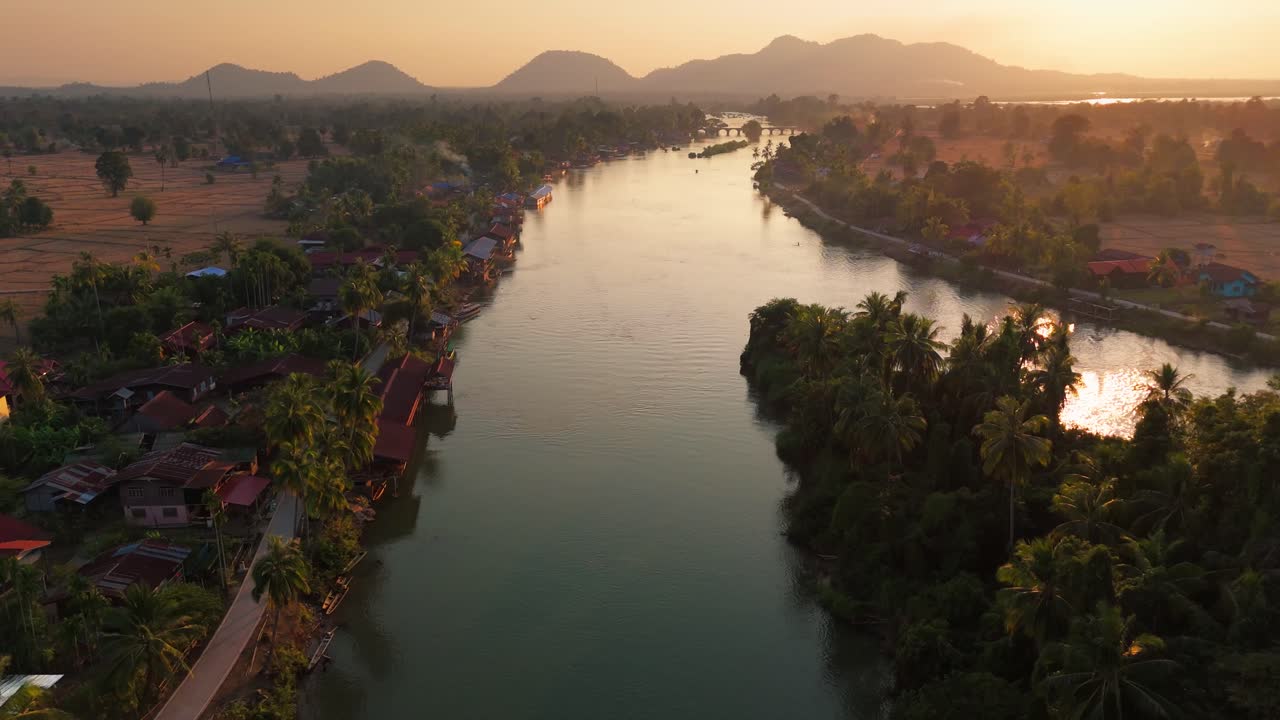Aerial sunset landscape in Mekong River, Laos 4000 Islands, reflection in traditional tropical Village