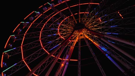 ferris wheel with lights rotates at night