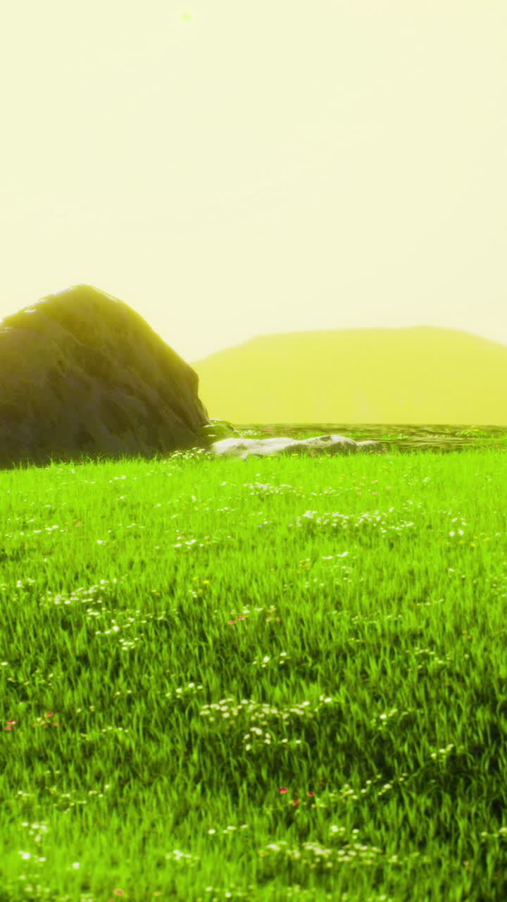 Serene landscape with green grass and distant hills during sunset hours