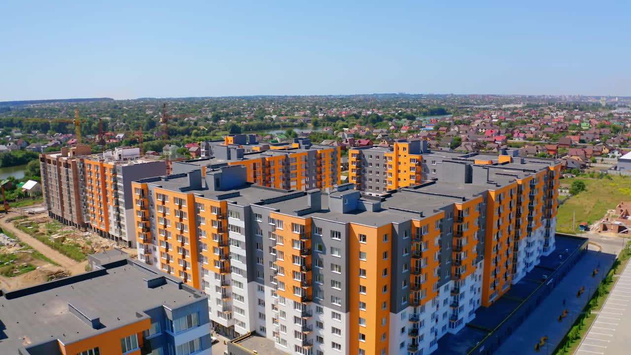 Modern residential apartment complex. High rise buildings with bright colorful facade. Concept of accommodation and urbanization. Aerial view.