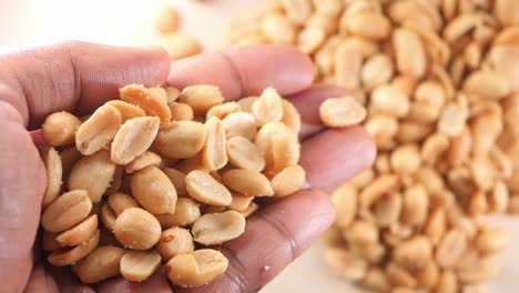 salted roasted peanuts in hand