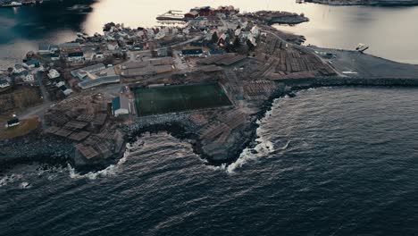 reine fishing village, soccer field, and hjeller til torrfisk in nordland, norway. - aerial shot