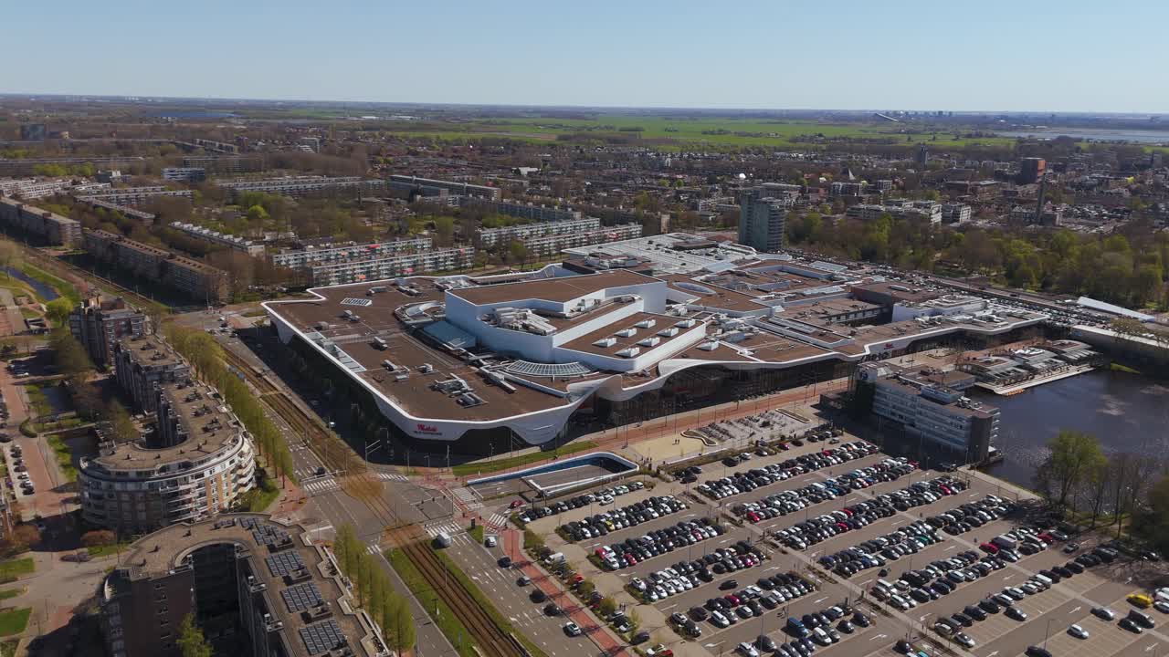 Wide aerial view of Westfield Mall in Leidschendam, surrounded by modern housing, roads, and open space. Captures a major commercial and architectural landmark in the region.