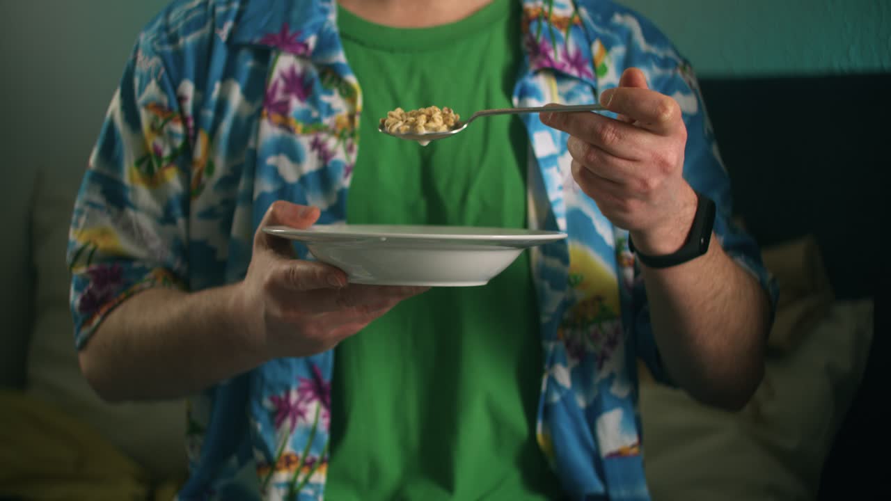 Man Eating Cereal for Breakfast in Bed