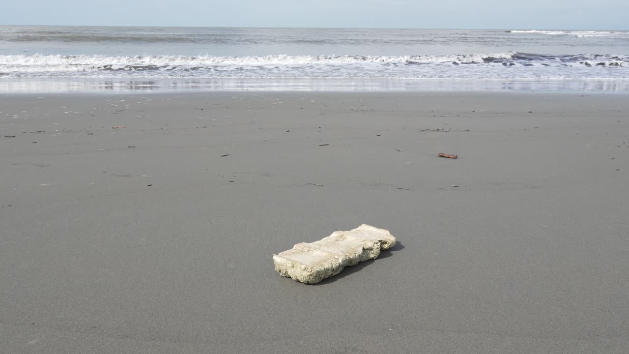 Piece of polystyrene on a sandy beach washed ashore Pacific coastline Colombia