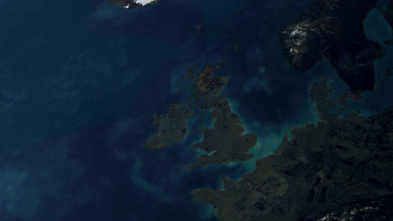 3d earth stylized spinning planet with lens flare sun zoom in to UK great britain